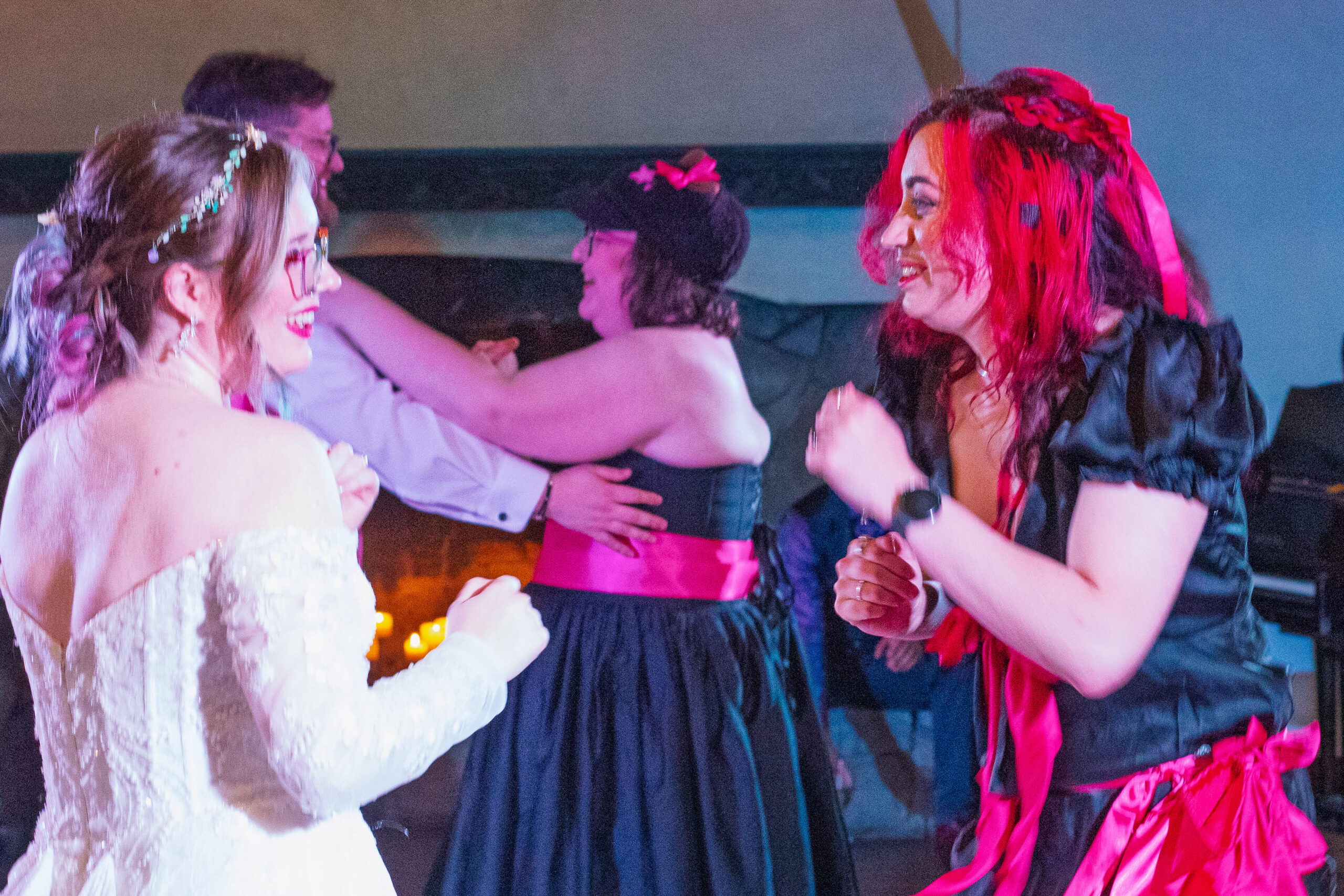 The bride and a bridesmaid dancing together later in the evening.