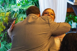 The officiant and bride hugging later in the evening.