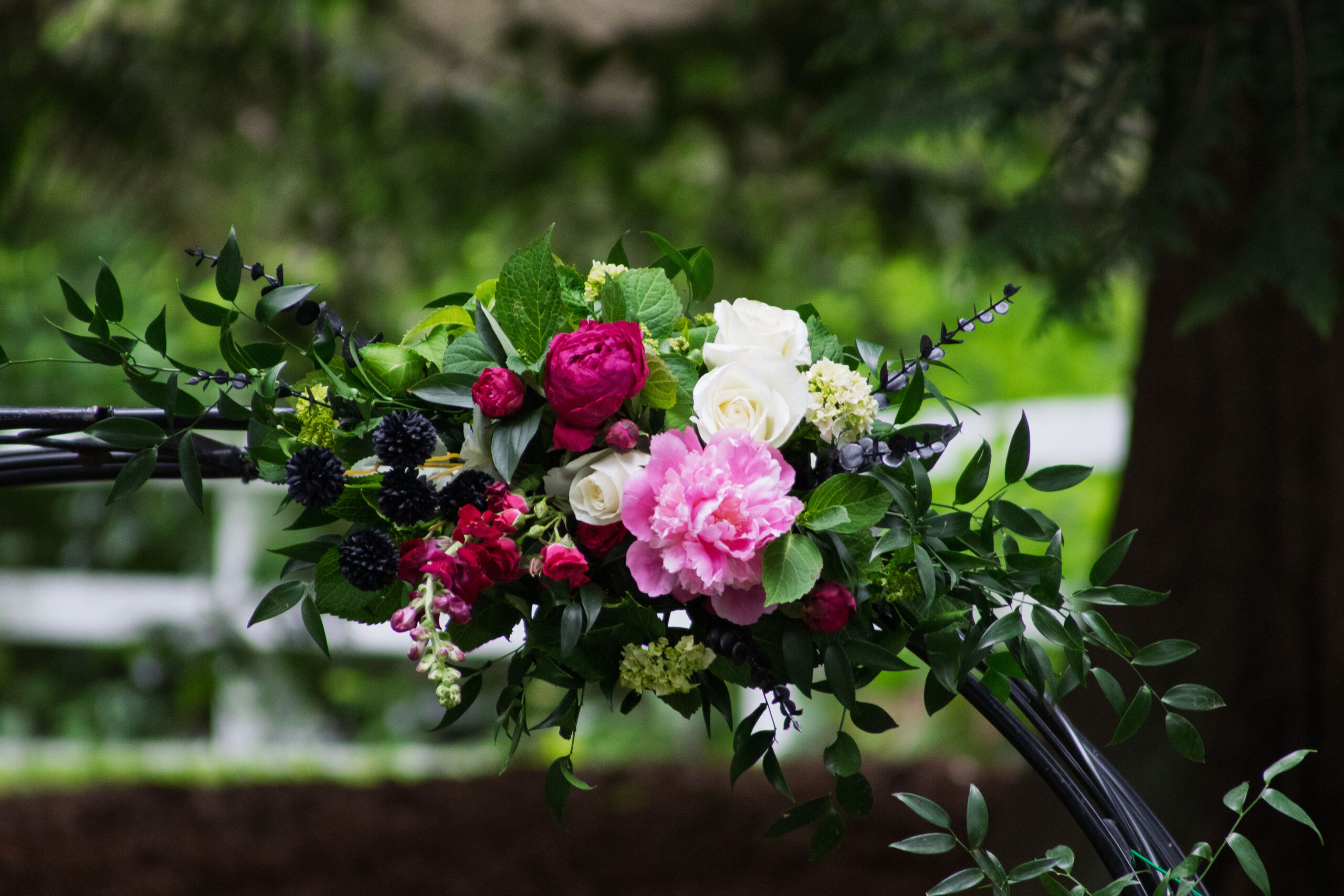 A shot of flowers on the wedding arch.