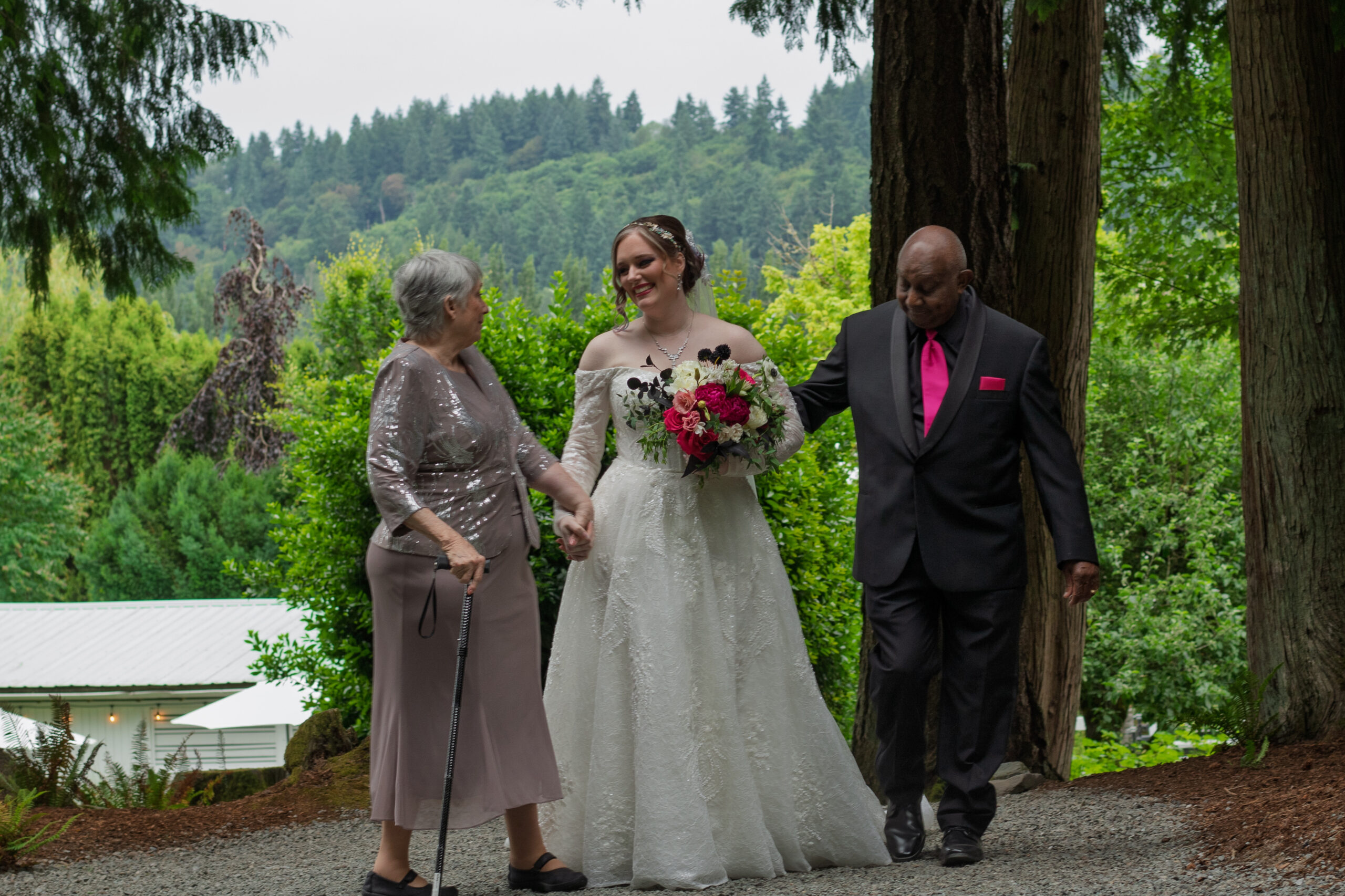 The bride walking up with her parents.